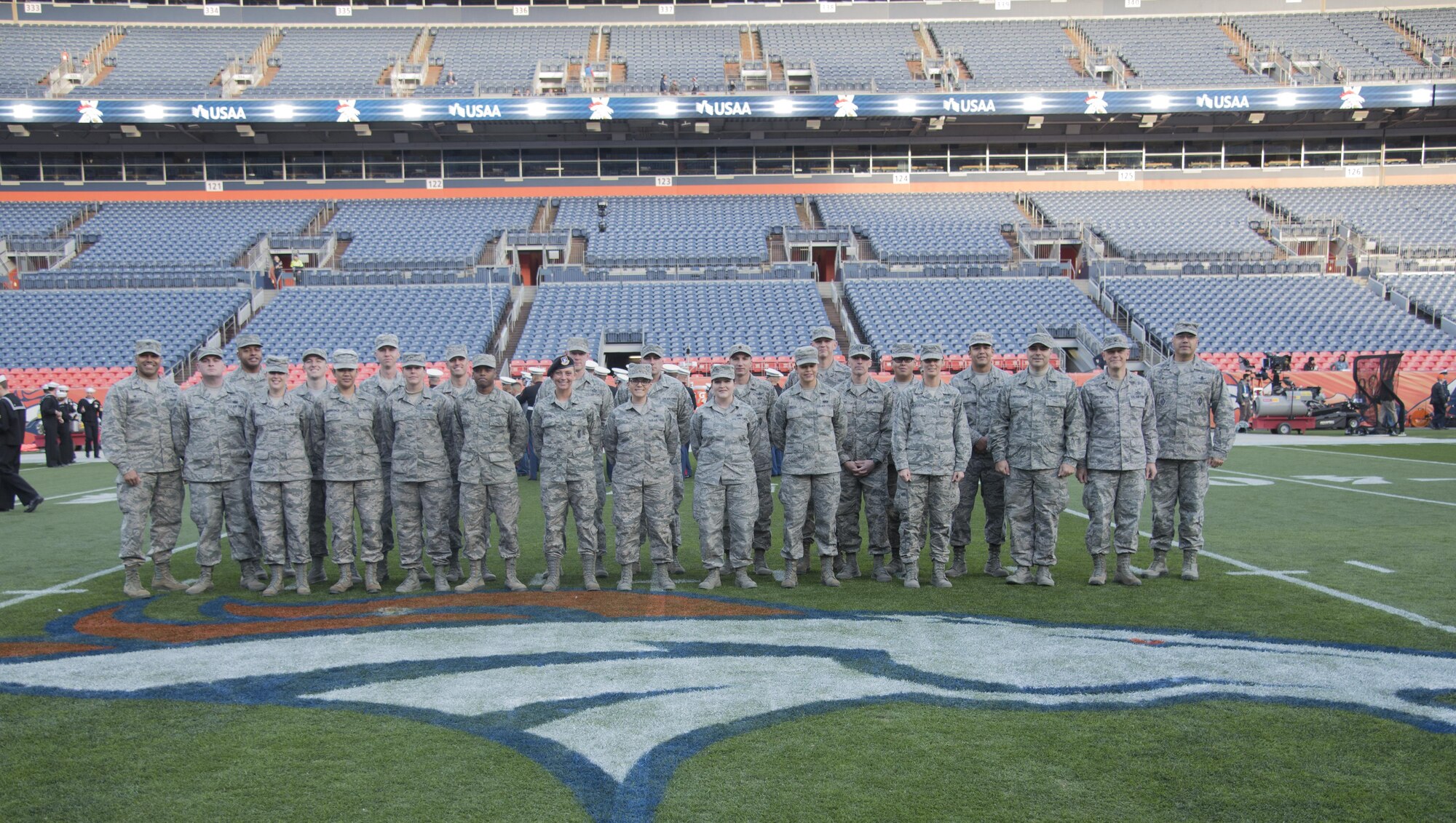 Team Buckley members gather for a group photo on the 50-yard line prior to rehearsing their pre-game ceremony roles Nov. 12, 2017, at Sports Authority Stadium at Mile High in Denver.