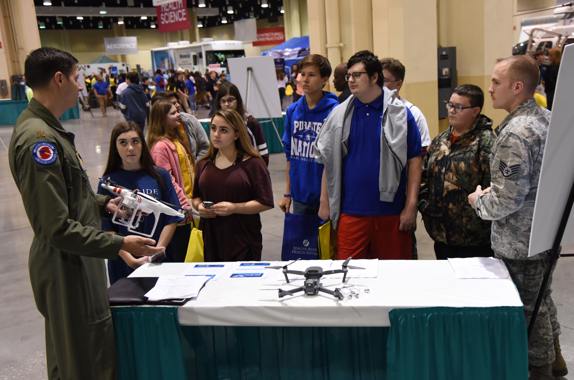 Maj. Dave Gentile, 53rd Weather Reconnaissance Squadron pilot, and Staff Sgt. Travis Schupp, 81st Operations Support Flight tower watch supervisor, explains the guidelines for flying drones near Keesler Air Force Base during the Pathways2Possibilities (P2P) event at the Mississippi Coast Coliseum & Convention Center Nov. 15, 2017, in Biloxi, Mississippi. P2P is a hands-on interactive career expo for all 8th graders and at-risk youth, ages 16-24 in South Mississippi. (U.S. Air Force photo by Kemberly Groue)