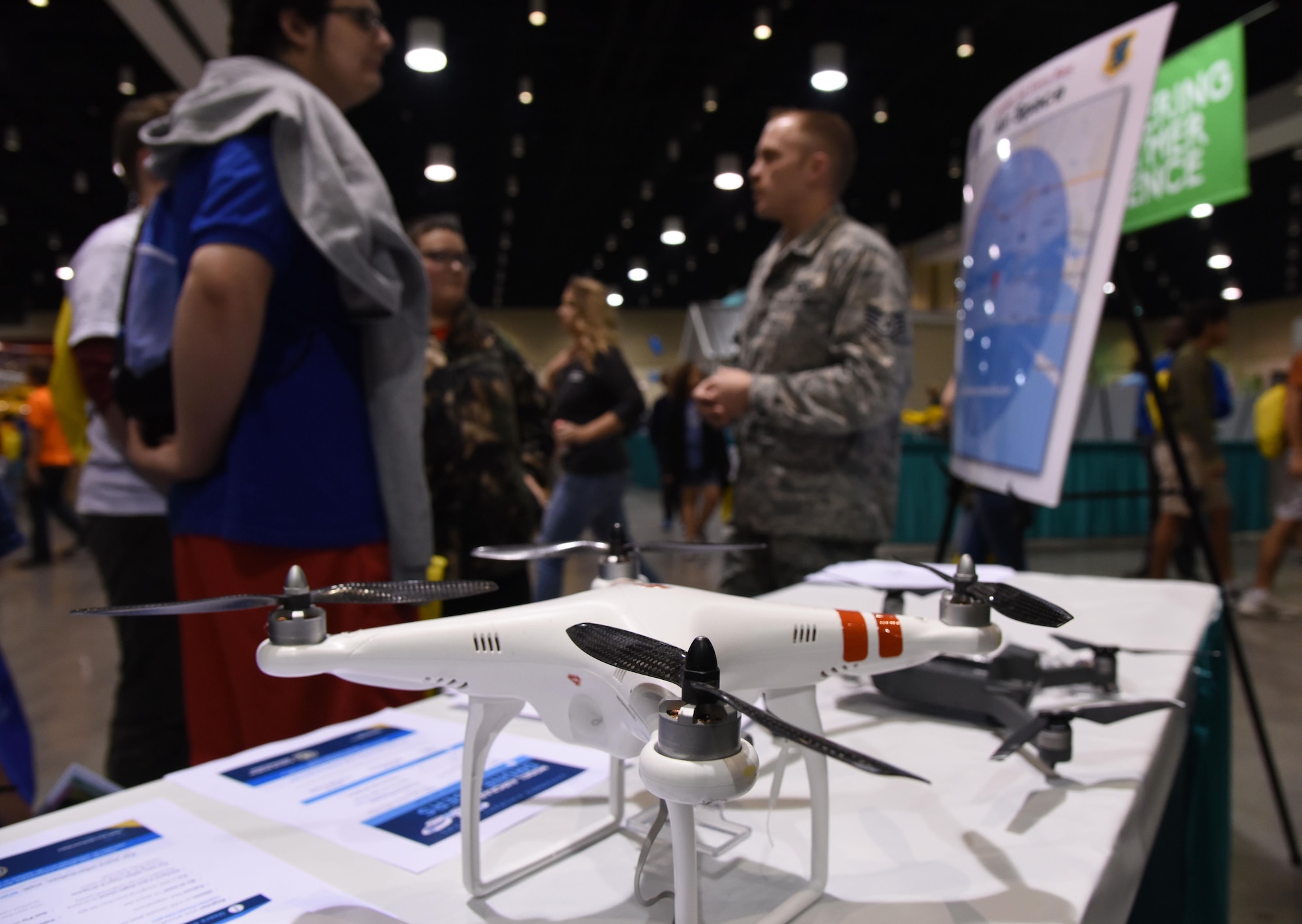 Staff Sgt. Travis Schupp, 81st Operations Support Flight tower watch supervisor, (right), explains the guidelines for flying drones near Keesler Air Force Base during the Pathways2Possibilities (P2P) event at the Mississippi Coast Coliseum & Convention Center Nov. 15, 2017, in Biloxi, Mississippi. P2P is a hands-on interactive career expo for all 8th graders and at-risk youth, ages 16-24 in South Mississippi. (U.S. Air Force photo by Kemberly Groue)