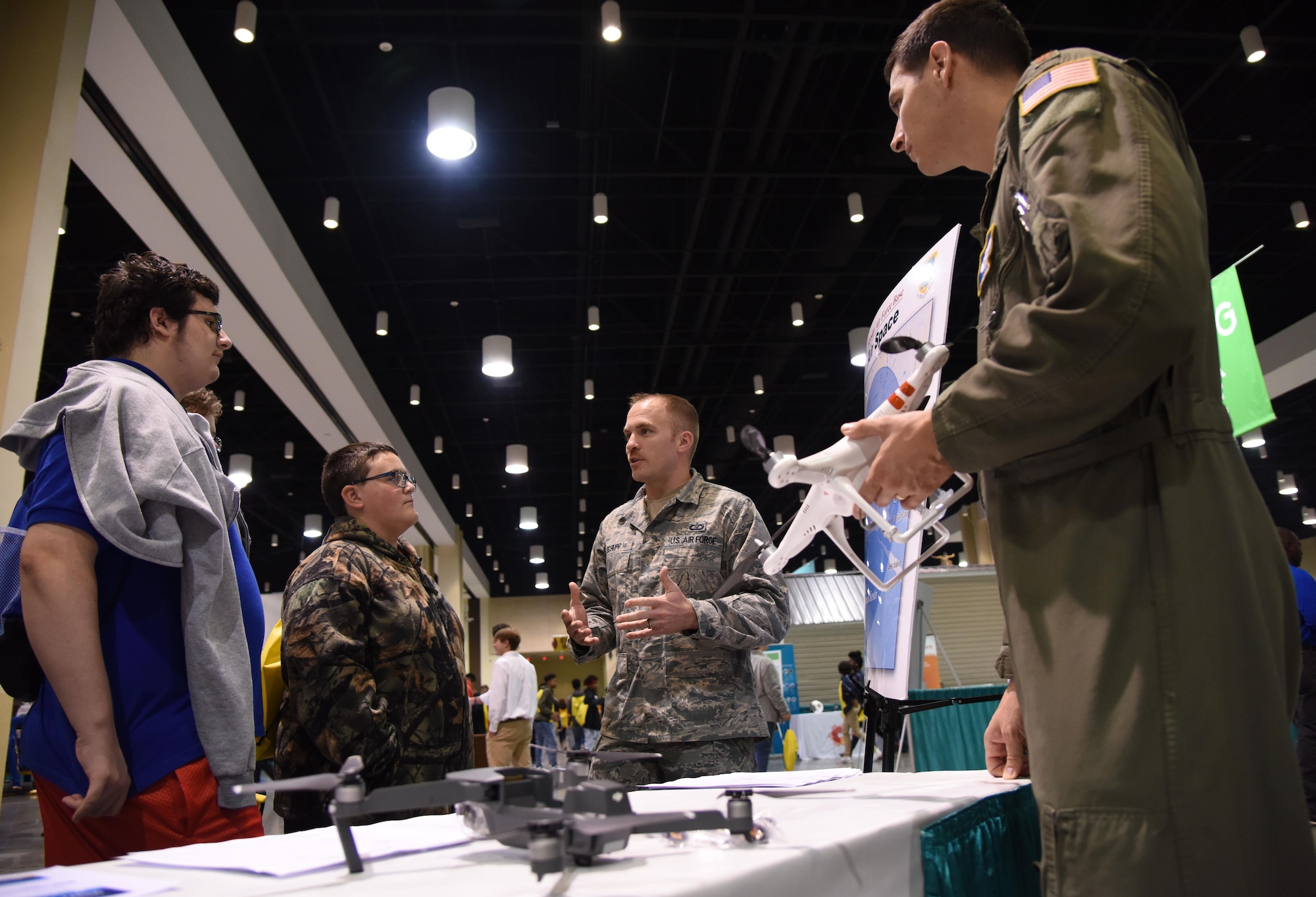 Staff Sgt. Travis Schupp, 81st Operations Support Flight tower watch supervisor,  and Maj. Dave Gentile, 53rd Weather Reconnaissance Squadron pilot, explains the guidelines for flying drones near Keesler Air Force Base during the Pathways2Possibilities (P2P) event at the Mississippi Coast Coliseum & Convention Center Nov. 15, 2017, in Biloxi, Mississippi. P2P is a hands-on interactive career expo for all 8th graders and at-risk youth, ages 16-24 in South Mississippi. (U.S. Air Force photo by Kemberly Groue)