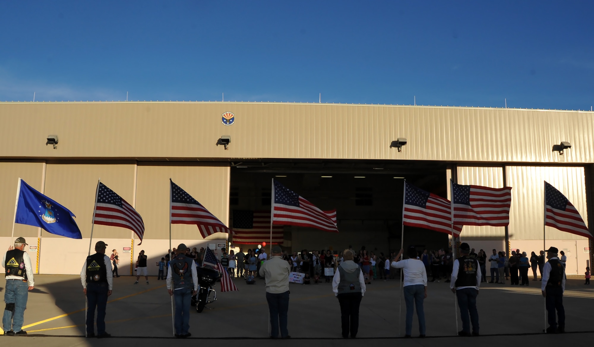 Members of the Arizona Patriot Guard Riders stand with American Flags.