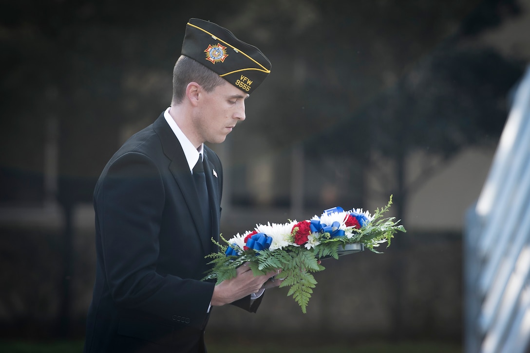 A veteran carries a memorial wreath during a Veterans Day Ceremony, Nov. 10, 2017, at Yokota Air Base, Japan.