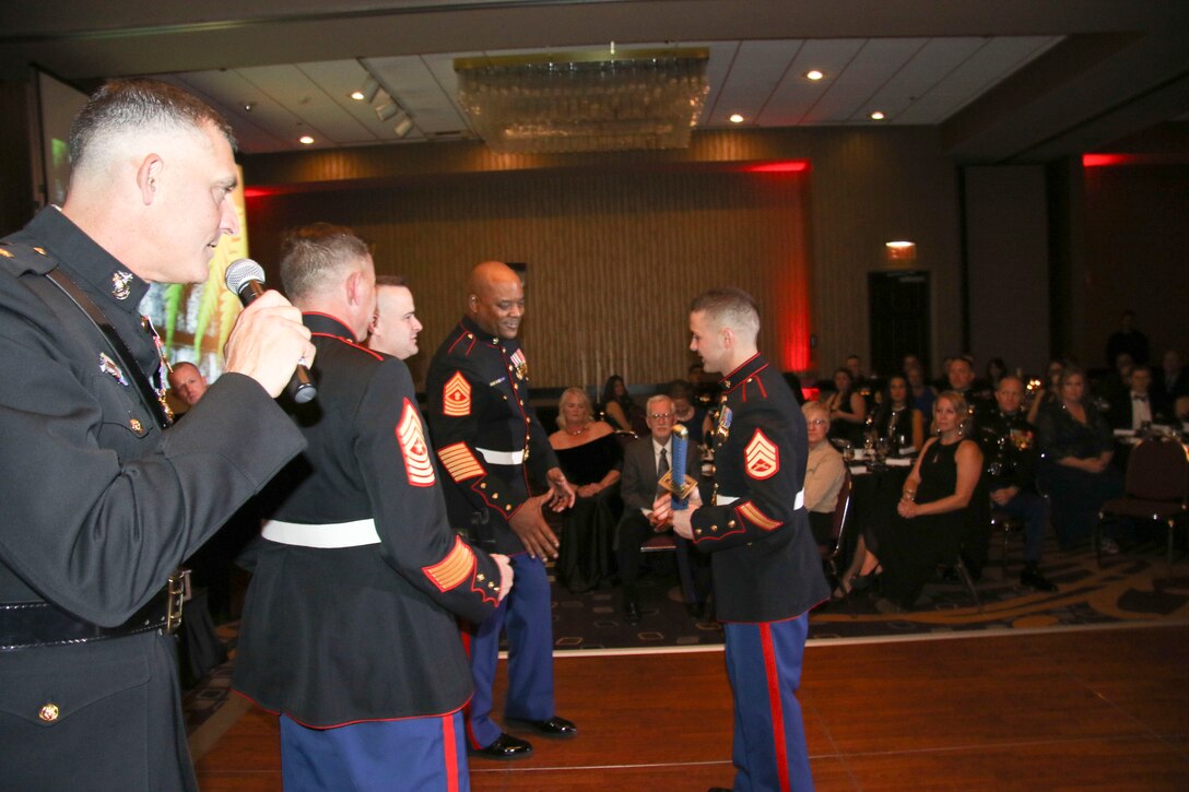 Staff Sgt. Jeremy Spaunhorst, staff noncommissioned officer-in-charge, Recruiting Substation West Omaha, Neb., receives a plaque for winning Marine Corps Recruiting Station Des Moines SNCOIC of the Year at Embassy Suites in Des Moines, Iowa, Nov. 11, during the 242nd Marine Corps Birthday Ball. (Official Marine Corps photo by Sgt. Levi Schultz)