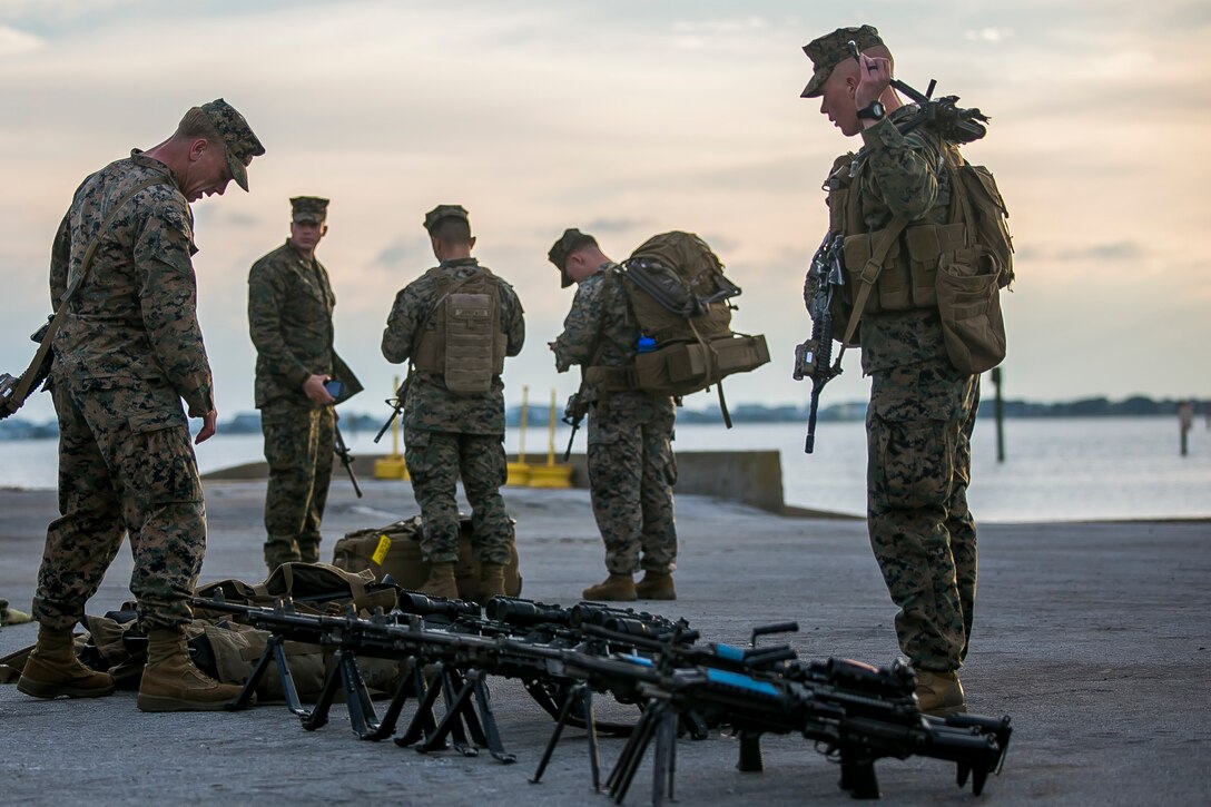 U.S. Marines with Fox Company, Battalion Landing Team (BLT), 2nd Battalion, 6th Marine Regiment, prepare weapons and equipment for embarkation aboard the dock landing ship USS Oak Hill (LSD 51) during Combined Composite Training Unit Exercise (COMPTUEX) at Morehead City, N.C., Nov. 14, 2017. COMPTUEX allows all elements of the Marine Air Ground Task Force to join and train in realistic scenarios so the MEU as a whole can meet its Predeployment Training Program objectives prior to an upcoming deployment at sea. (U.S. Marine Corps photo by Staff Sgt. Dengrier M. Baez)