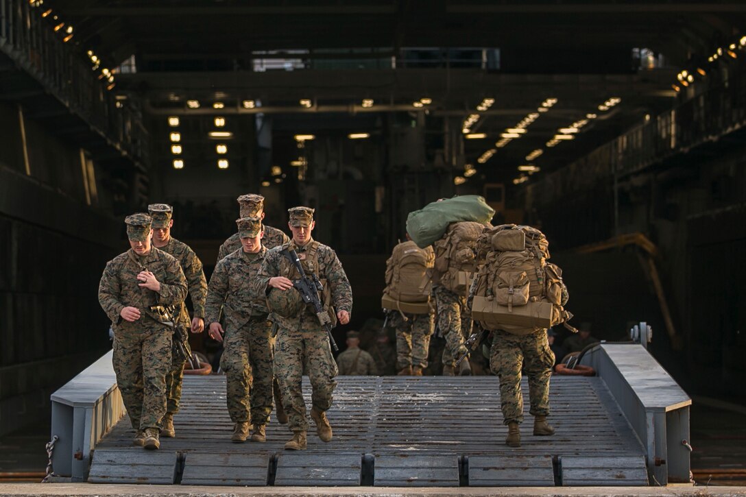 U.S. Marines with Fox Company, Battalion Landing Team (BLT), 2nd Battalion, 6th Marine Regiment, load equipment from the pier onto the dock landing ship USS Oak Hill (LSD 51) during Combined Composite Training Unit Exercise (COMPTUEX) at Morehead City, N.C., Nov. 14, 2017. COMPTUEX allows all elements of the Marine Air Ground Task Force to join and train in realistic scenarios so the MEU as a whole can meet its Predeployment Training Program objectives prior to an upcoming deployment at sea. (U.S. Marine Corps photo by Staff Sgt. Dengrier M. Baez)