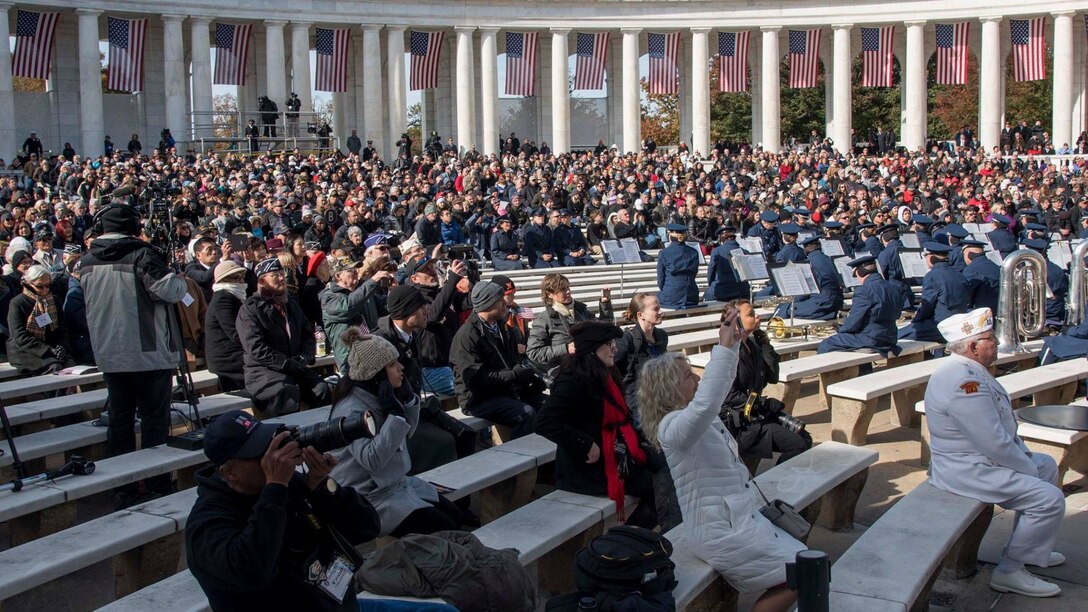 Veterans Day ceremony attendees sit in the crowd