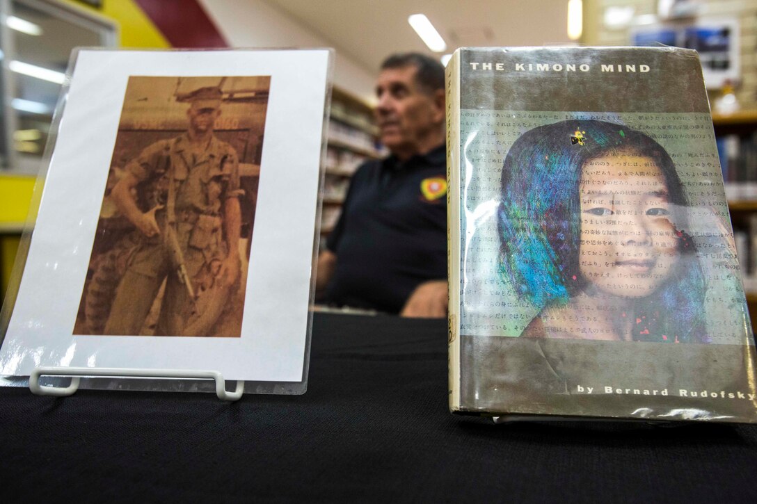 Retired U.S. Marine Corps Willis "Bill" Hansen returns his library book 52 years later at the Camp Hansen library, Okinawa, Japan, Oct. 26, 2017.