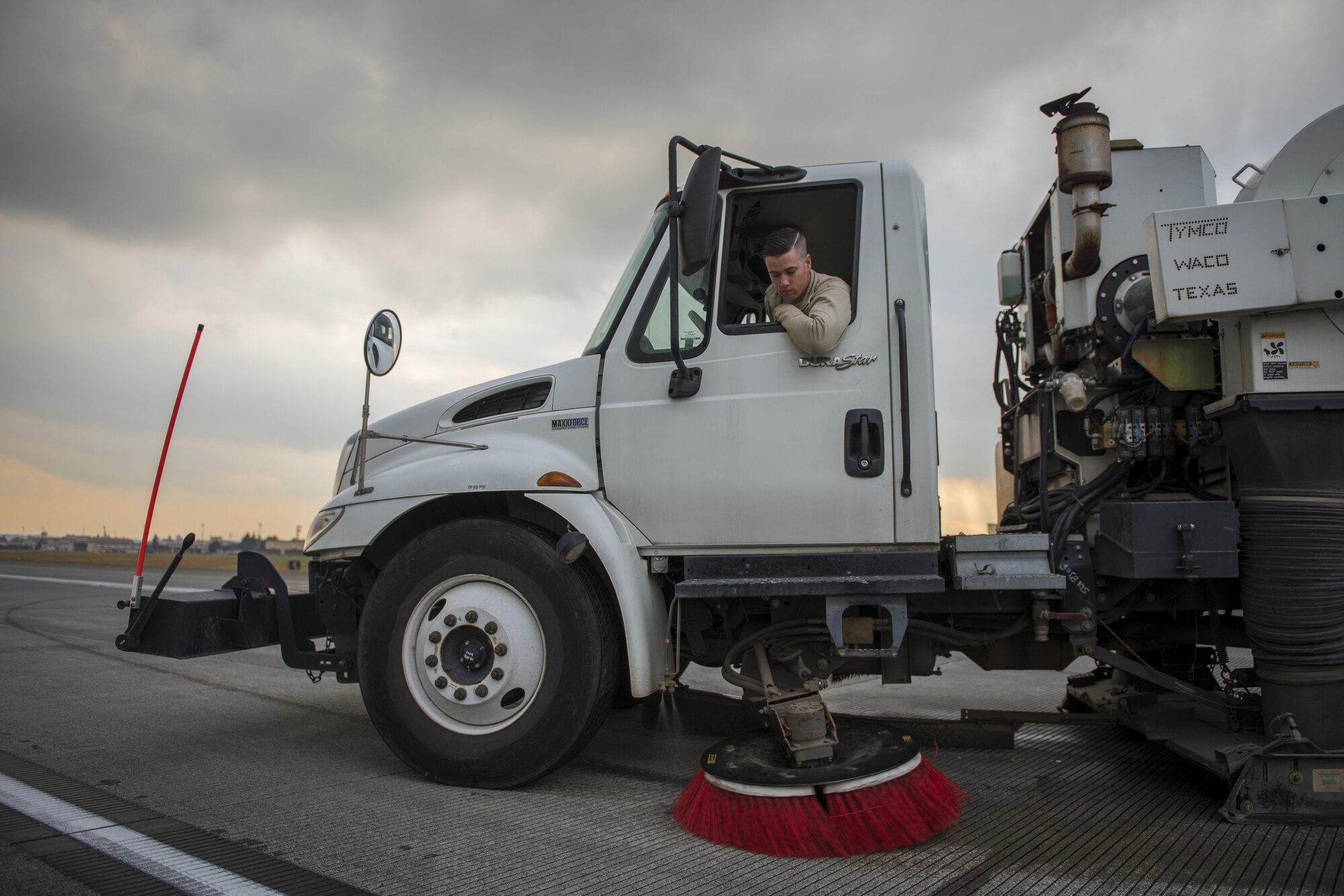 Airman 1st Class Taj Zook, 374th Civil Engineer Squadron pavements and equipment, cleans part of the runway after a concrete repair, Nov. 15, 2017, at Yokota Air Base, Japan.