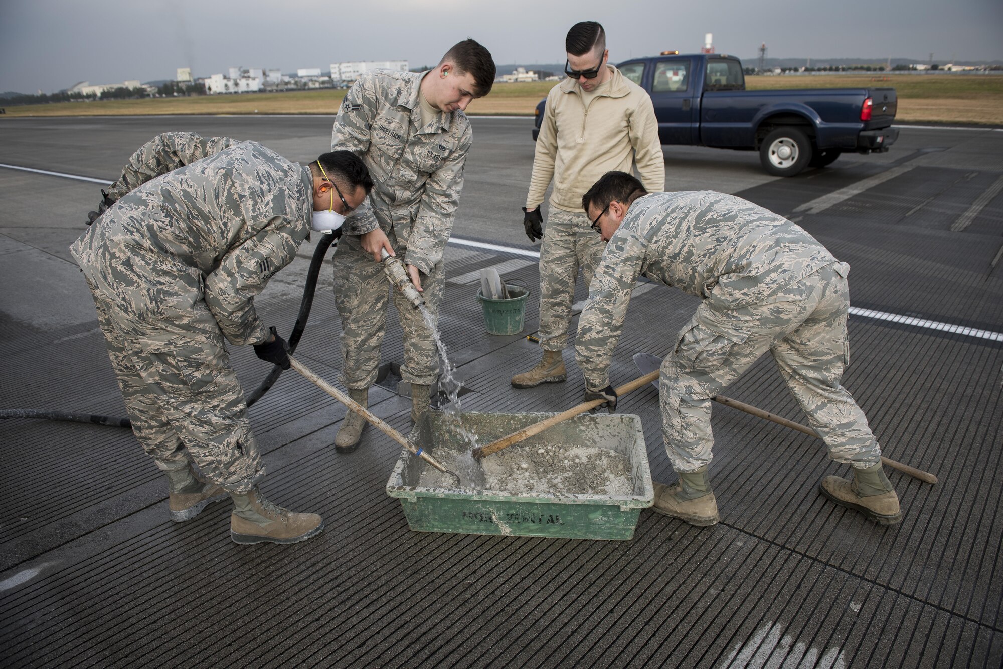 Pavements and equipment journeymen with the 374th Civil Engineer Squadron mix concrete for a runway repair, Nov. 15, 2017, at Yokota Air Base, Japan.
