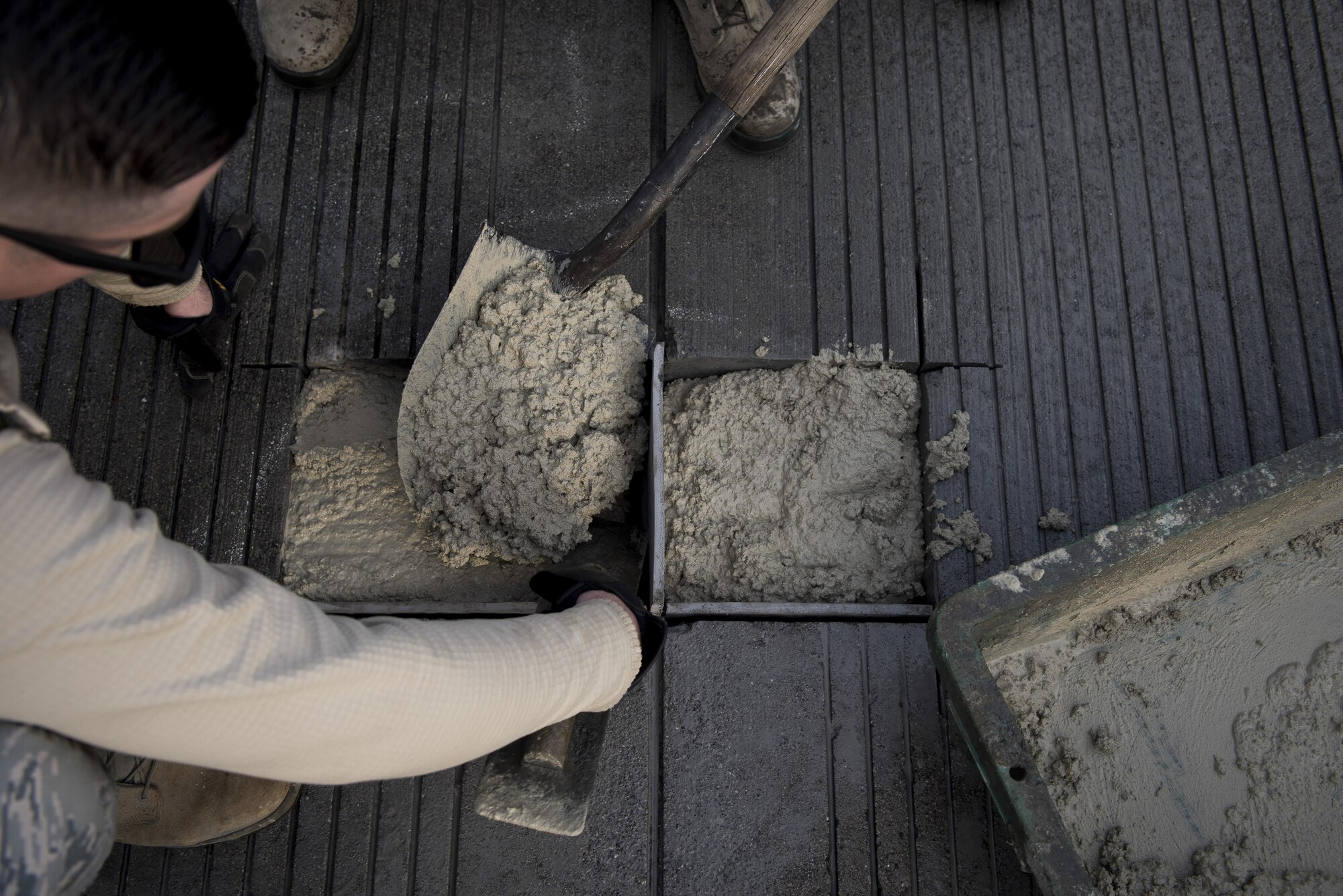 Pavements and equipment journeymen with the 374th Civil Engineer Squadron set concrete during a runway repair, Nov. 15, 2017, at Yokota Air Base, Japan.