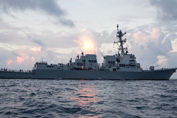 A military ship floats on the water.