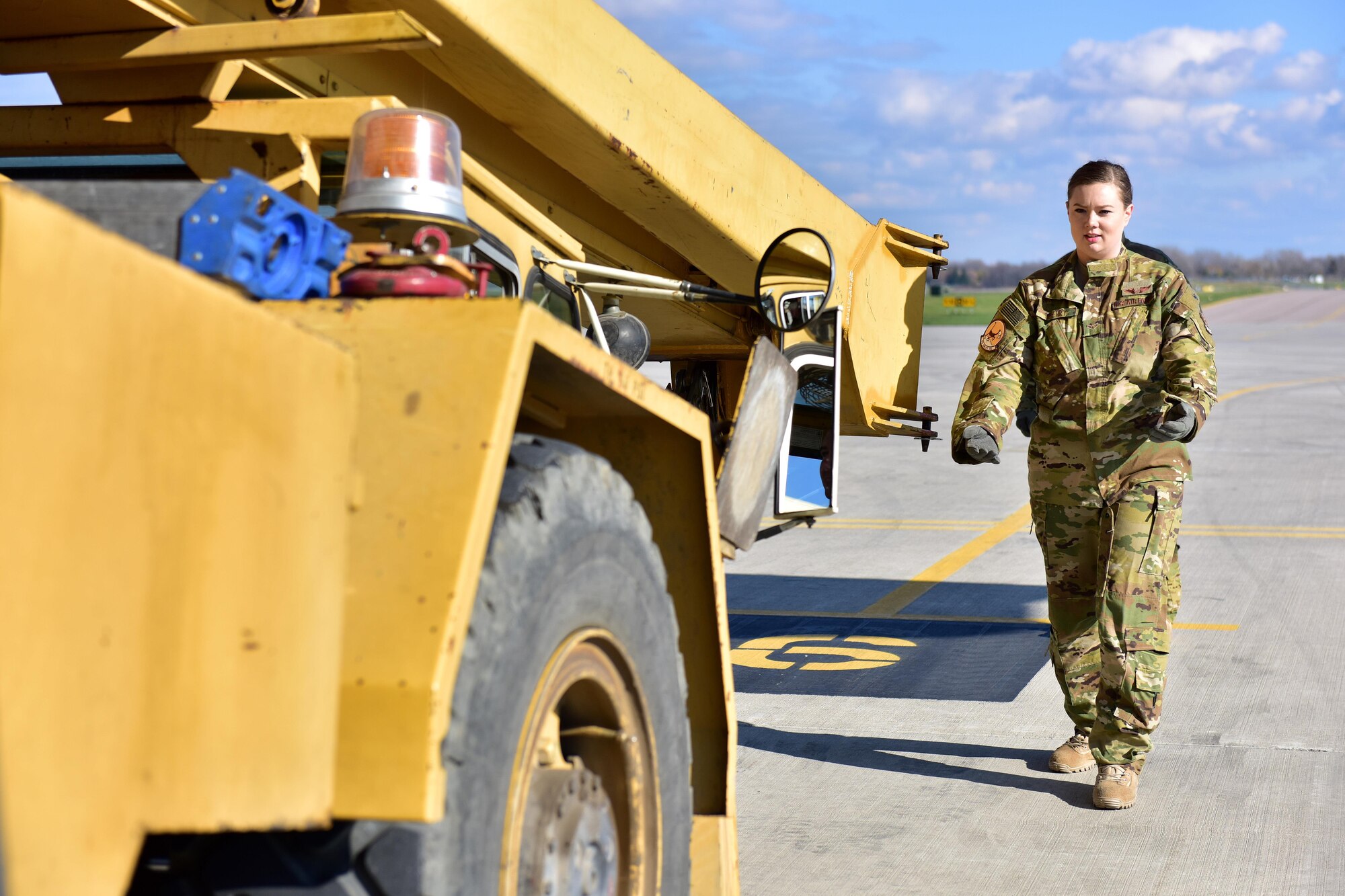 Airman 1st Class Brittany Deberry, 41st Airlift Squadron loadmaster, guides a Canadian crane truck onto a Little Rock Air Force base C-130J at Canadian Forces base Trenton in Ontario, Canada, Nov. 7, 2017.  The unique size and shape of the crane provided training for the loadmasters they normally don’t encounter at Little Rock AFB. (U.S. Air Force photo by SSgt Jeremy McGuffin)