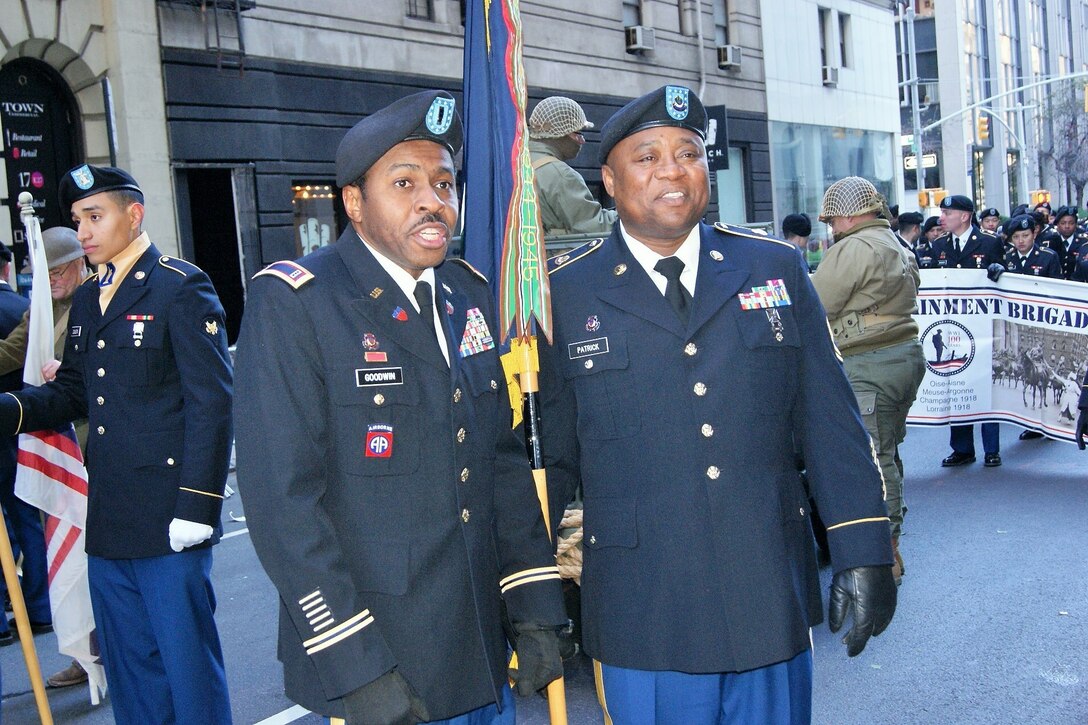 (Left to right) Chief Warrant Officer 3 Eric Goodwin and Sgt. 1st Class Karl Patrick, of the 3rd Brigade Civil Affairs/Military Information Special Operations, 102nd Training Division, 80th Training Command, answer questions in a live-streaming video interview at the New York City Veterans Day Parade Nov. 11, 2017.