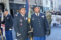 (Left to right) Chief Warrant Officer 3 Eric Goodwin and Sgt. 1st Class Karl Patrick, of the 3rd Brigade Civil Affairs/Military Information Special Operations, 102nd Training Division, 80th Training Command, answer questions in a live-streaming video interview at the New York City Veterans Day Parade Nov. 11, 2017.