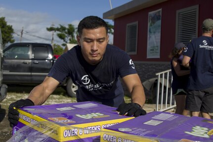 Soldier Unloads Pallet of Diaper Boxes