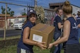 Volunteer Passes Box of Groceries