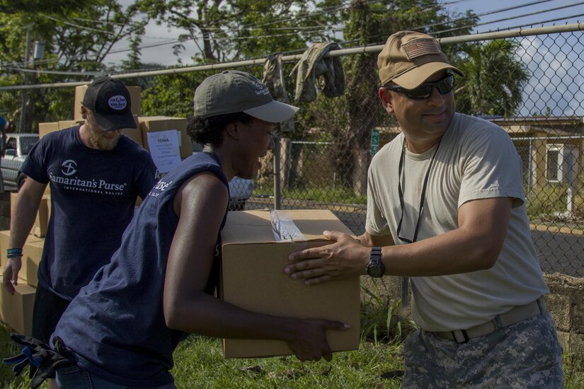 Soldier Passes Box of Groceries