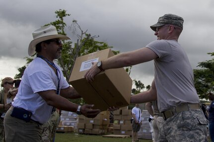 Soldier Passes Box of Groceries