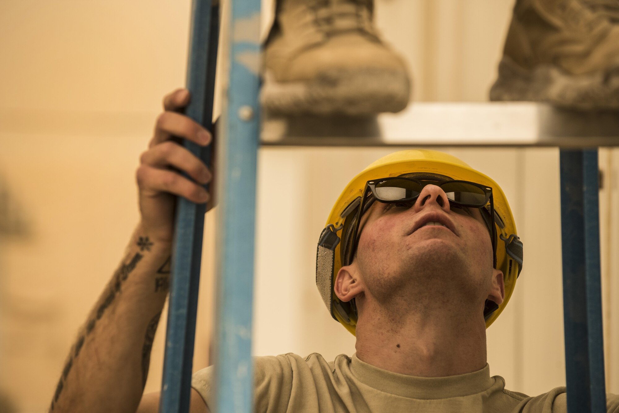 SrA Jacob Ferreira, assigned to the 332nd Expeditionary Communications Squadron, secures a ladder for a teammate during a base-wide wireless internet improvement project Nov. 13, 2017 in Southwest Asia. Installing new infrastructure of any kind in austere environments requires a high level of focus on safety and attention to detail. (U.S. Air Force by Senior Airman Joshua Kleinholz