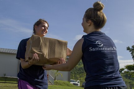 Volunteer Passes Box of Groceries