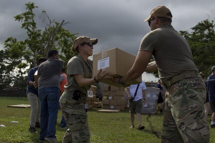 Soldier Passes Box of Groceries