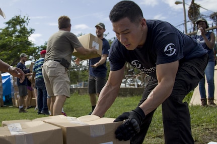 Volunteer Unloads Boxes of Groceries