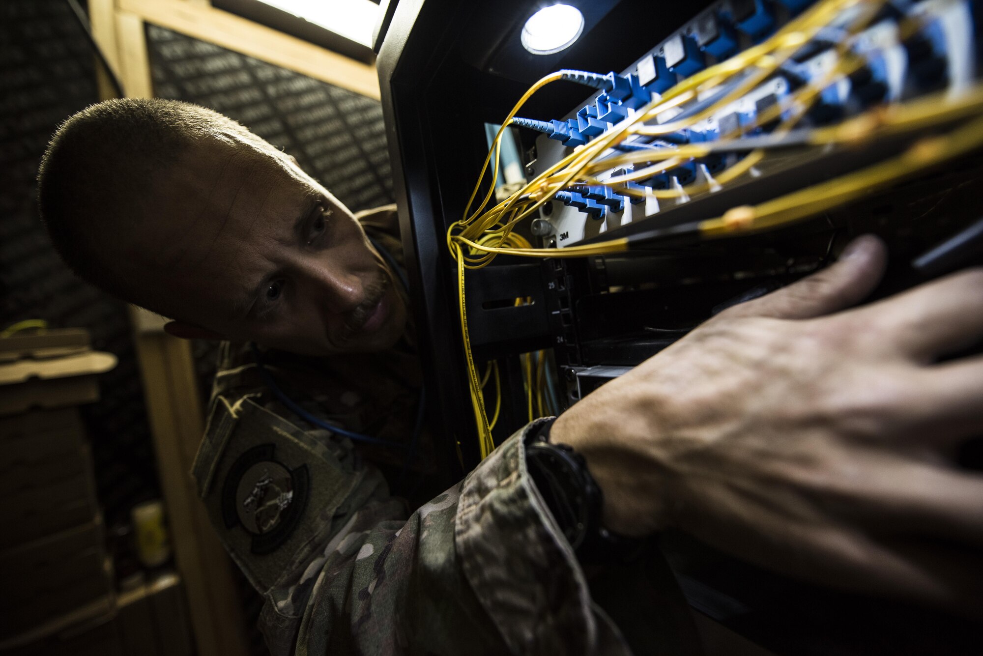 SMSgt Brandon McCoy, 332nd Expeditionary Communications Squadron Superintendent, checks the installation of new wireless internet firewall equipment Nov. 13, 2017, in Southwest Asia. The firewall improvements will ensure a safe, reliable connection to the web for deployed service members. (U.S. Air Force by Senior Airman Joshua Kleinholz)