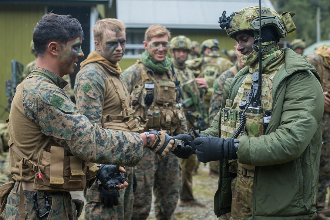 U.S. Marine Corps Lance Cpl. Jadon Valdez, left, a rifleman with 1st Light Armored Reconnaissance Battalion, 1st Marine Division, exchanges a gift with Royal Australian Army Cpl. Shanil Mudaliar, right, a rifleman with 1st Royal Australian Regiment, after an ambush of simulated enemy forces during exercise Southern Katipo 17 (SK17), at St. Arnaud, New Zealand, Oct. 29, 2017.