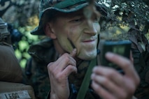 U.S. Marine Corps Lance Cpl. Ryan Savage, a rifleman with 1st Light Armored Reconnaissance Battalion, 1st Marine Division, applies camouflage paint during Exercise Southern Katipo 17 (SK17), at St. Arnaud, New Zealand, Oct. 28, 2017.