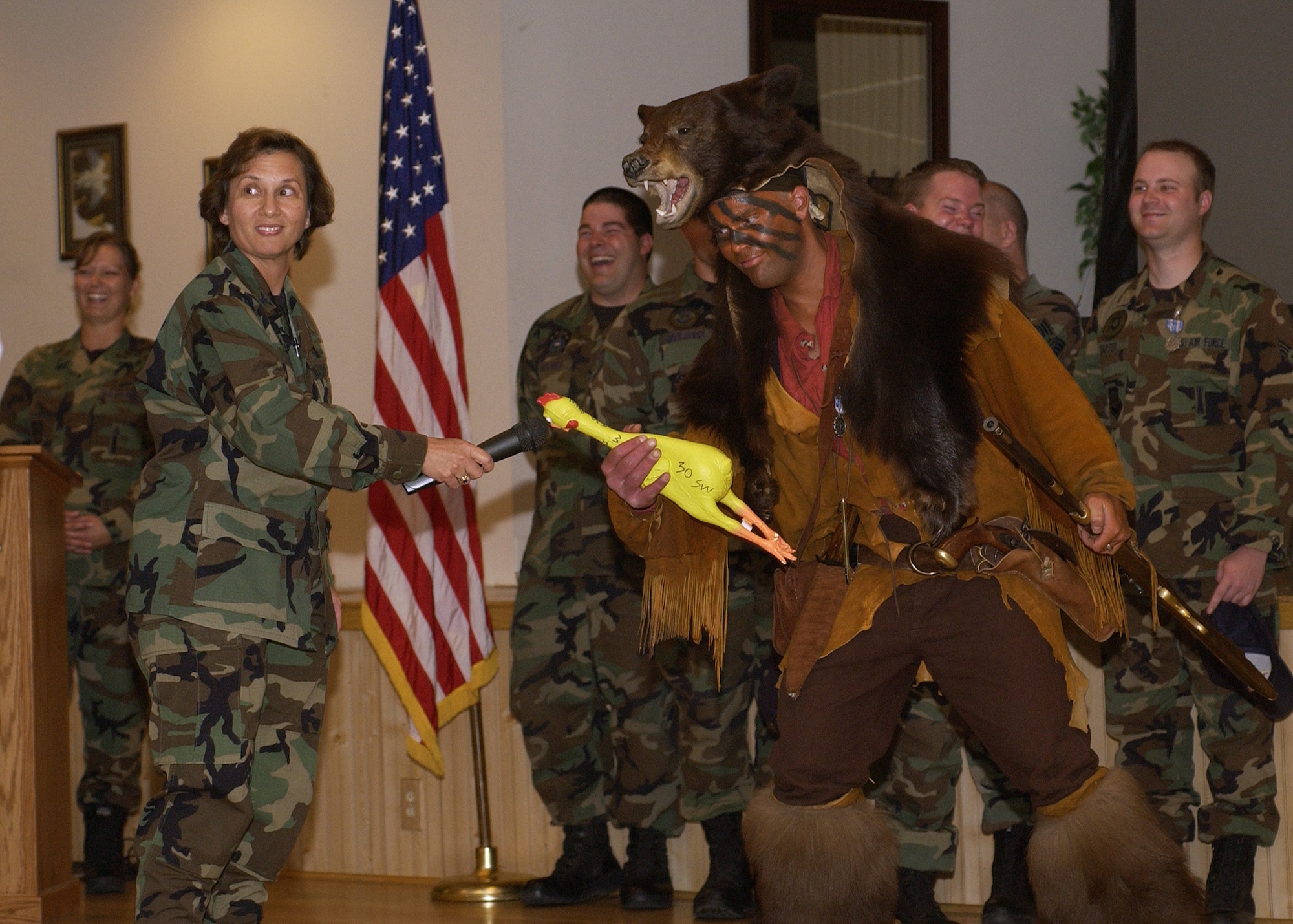 Col. Sandra Finan, 341st Space Wing commander, left, and Grizzly, the 341st SW Guardian Challenge team mascot, entertain an audience during competition return celebration Aug. 21, 2006, at Malmstrom Air Force Base, Mont. The 341st SW won the Blanchard Trophy for Best ICBM Wing at Air Force Space Command’s Guardian Challenge 2006 Space and Missile Competition. The wing mascot’s appearance has changed very little since this photo was taken. (U.S. Air Force photo)