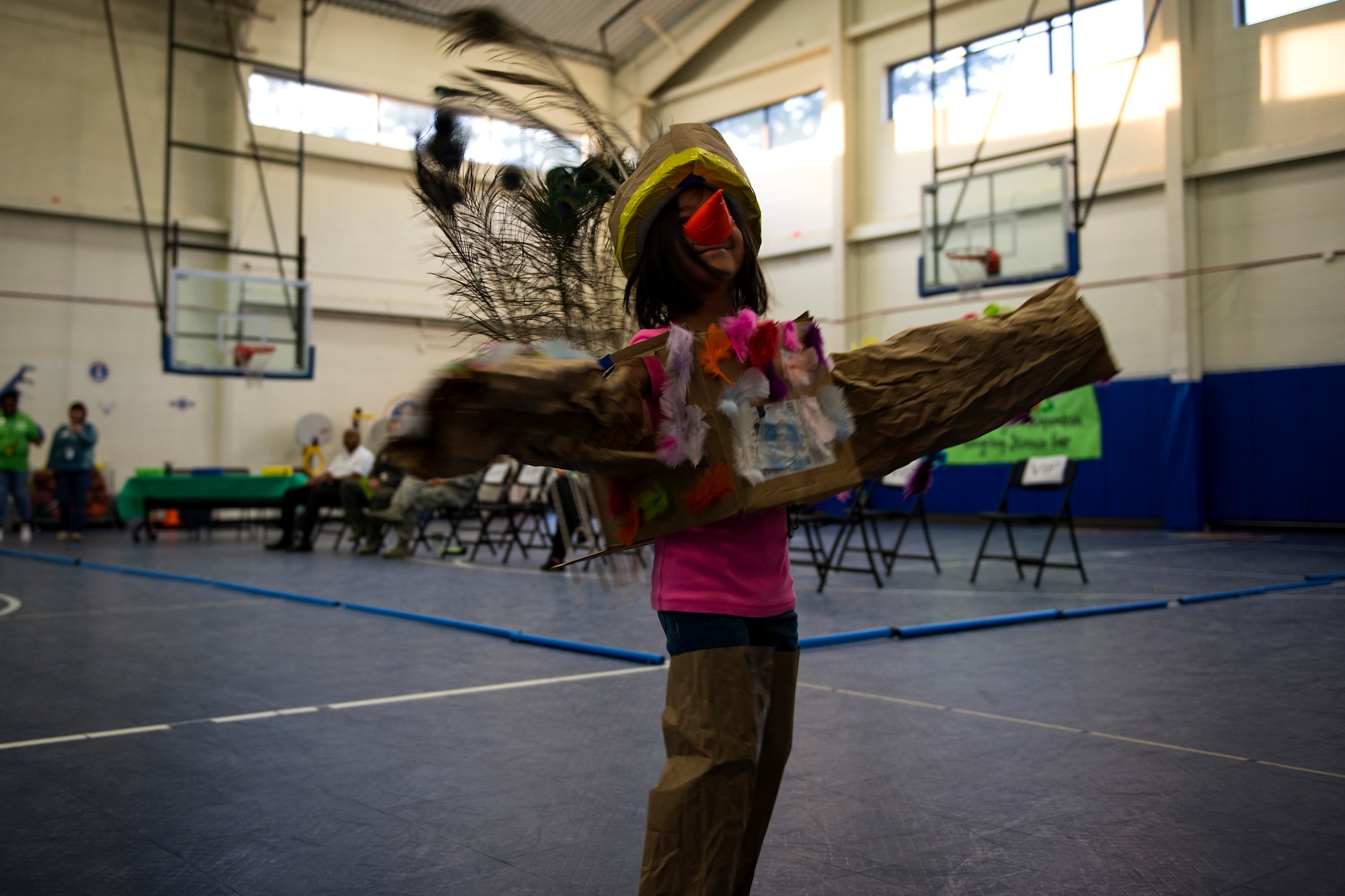 A fashion show participant dressed as a bird poses for a photo during the 23d Civil Engineer Squadron Recycling Science Fair, Nov. 15, 2017, at Moody Air Force Base, Ga. The 23d CES partnered with Moody's Youth Programs for America Recycles Day. The event consisted of a fashion show, where everything was made out of recycled materials. It was designed to help foster more interest in recycling, to increase recycling on base and promote less solid waste to landfills. (U.S. Air Force photo by Airman 1st Class Erick Requadt)