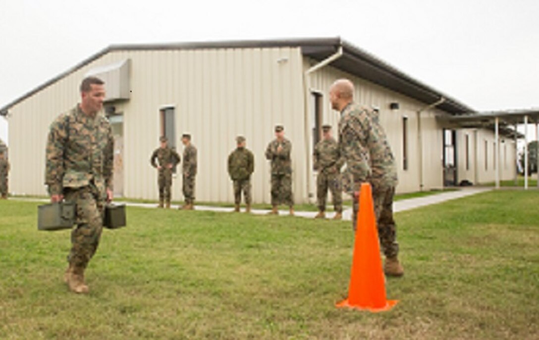 Master Gunnery Sgt. Benjamin Gonzalez, avionics chief, Aviation Logistics Division, U.S. Marine Corps Forces Command, carries two 30-pound ammo cans during the “maneuver under fire” event as part of the Combat Fitness Test at Headquarters and Service Battalion building, at Camp Allen, Norfolk, Va., Nov. 15. Marines are required to take the CFT annually in addition to the Physical Fitness Test to evaluate physical fitness and combat readiness. (Official Marine Corps photo by Chris Jones/Released)