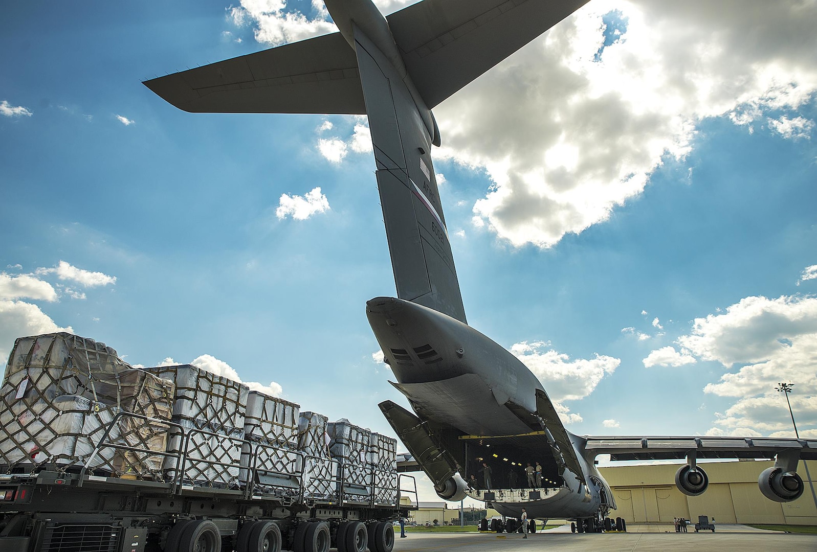 A Halvorsen Loader backs up to the ramp of a C-5M Super Galaxy aircraft at the 433rd Airlift Wing in support of Hurricane Harvey relief efforts August, 30, 2017 at Joint Base San Antonio-Lackland, Texas.