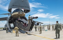 Soldiers from the 1st Air Cavalry Brigade, 1st Cavalry Division Ft. Hood, Texas and Airmen from the 26th and 74th Aerial Port Squadrons begin loading a UH-60 Black Hawk helicopter into the cargo hold of a C-5M Super Galaxy aircraft June 22, 2017 at Joint Base San Antonio-Lackland.