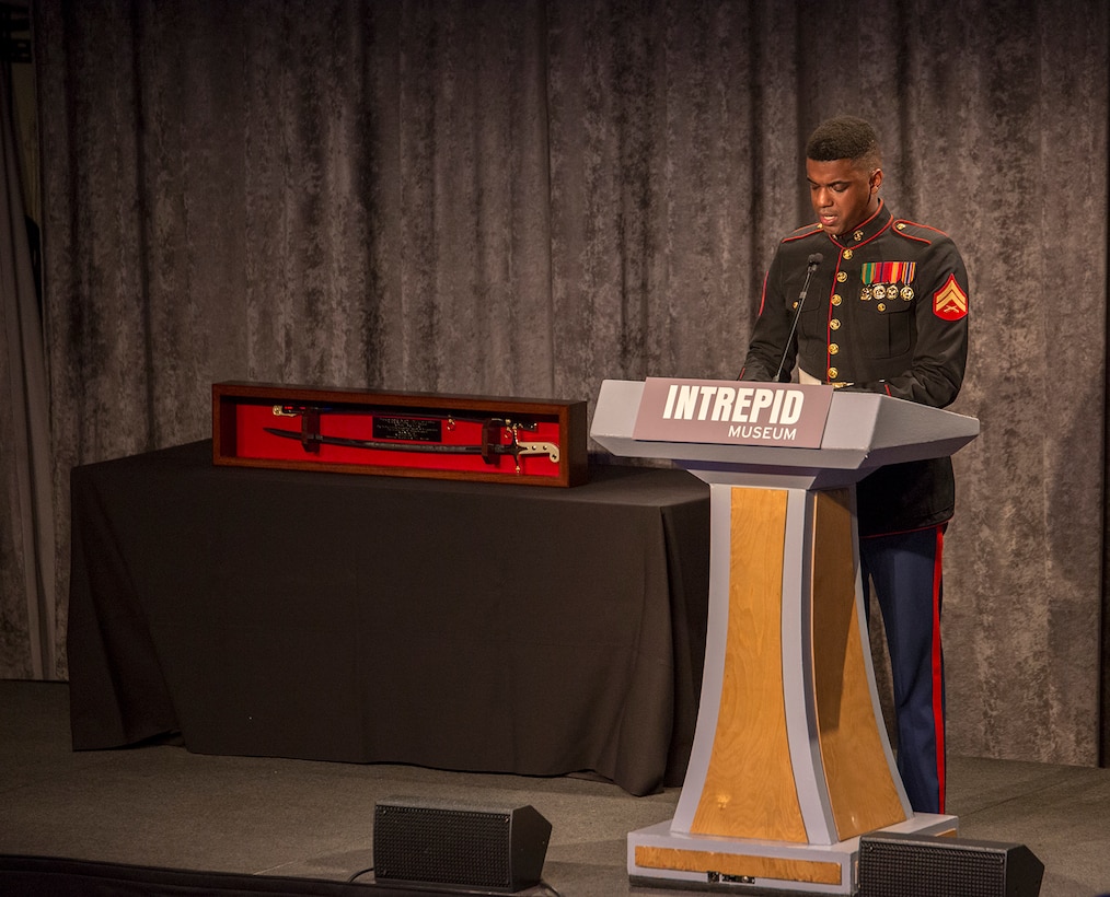 Corporal Andre Bastian, narrator, “The Commandant’s Own” U.S. Marine Drum & Bugle Corps, speaks during the 242nd Marine Corps Birthday Gala aboard the USS Intrepid Sea, Air, and Space Museum, New York City, NY, Nov. 8, 2017. Every year, the Barracks travels throughout the National Capital Region and numerous other locations to honor and celebrate the birthday of the Corps. (Official U.S. Marine Corps photo by Cpl. Robert Knapp/Released)