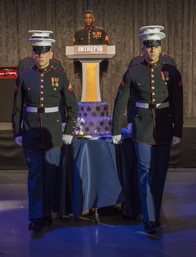A cake cutting detail with Marine Barracks Washington D.C., presents the birthday cake during the 242nd Marine Corps Birthday Gala aboard the USS Intrepid Sea, Air, and Space Museum, New York City, NY, Nov. 8, 2017. Every year, the Barracks travels throughout the National Capital Region and numerous other locations to honor and celebrate the birthday of the Corps. (Official U.S. Marine Corps photo by Cpl. Robert Knapp/Released)