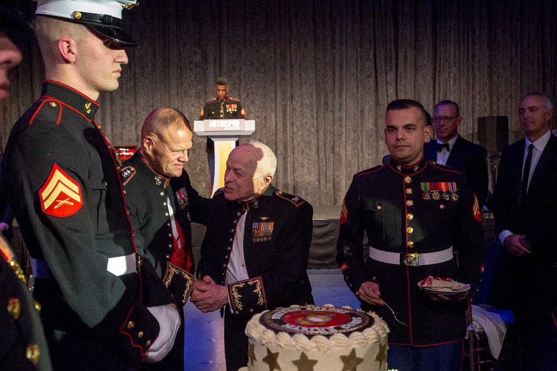 The oldest Marine present, retired Col. Jonathan Mendes, shakes hands with the Commandant of the Marine Corps, Gen. Robert B. Neller, during the 242nd Marine Corps Birthday Gala aboard the USS Intrepid Sea, Air, and Space Museum, New York City, NY, Nov. 8, 2017. Every year, the Barracks travels throughout the National Capital Region and numerous other locations to honor and celebrate the birthday of the Corps. (Official U.S. Marine Corps photo by Cpl. Robert Knapp/Released)