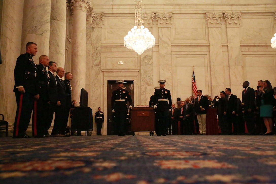 A cake cutting detail with Marine Barracks Washington D.C., marches with the traditional birthday cake during a cake cutting ceremony to celebrate the Marine Corps’ 242nd birthday at the Russell Senate Office Building, Washington D.C., Nov. 15, 2017. The guest of honor for the ceremony was the Senator of Indiana, the Honorable Todd Young, and the hosting official was the Commandant of the Marine Corps, Gen. Robert B. Neller. (Official U.S. Marine Corps photo by Cpl. Robert Knapp/Released)