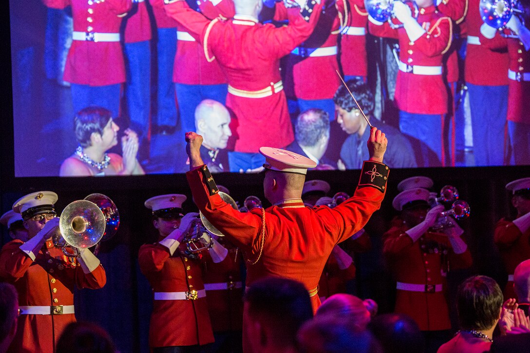 Captain James D. Foley, executive officer, “The Commandant’s Own” U.S. Marine Drum & Bugle Corps, conducts the D&B during the 242nd Marine Corps Birthday Gala aboard the USS Intrepid Sea, Air, and Space Museum, New York City, NY, Nov. 8, 2017. Every year, the Barracks travels throughout the National Capital Region and numerous other locations to honor and celebrate the birthday of the Corps. (Official U.S. Marine Corps photo by Cpl. Robert Knapp/Released)