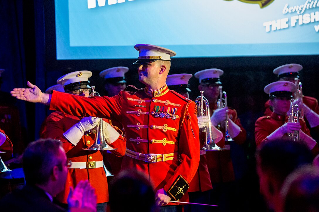 Captain James D. Foley, executive officer, “The Commandant’s Own” U.S. Marine Drum & Bugle Corps, conducts the D&B during the 242nd Marine Corps Birthday Gala aboard the USS Intrepid Sea, Air, and Space Museum, New York City, NY, Nov. 8, 2017. Every year, the Barracks travels throughout the National Capital Region and numerous other locations to honor and celebrate the birthday of the Corps. (Official U.S. Marine Corps photo by Cpl. Robert Knapp/Released)