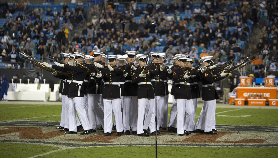 The U.S. Marine Corps Silent Drill Platoon executes their “bursting bomb” sequence during a Salute to Service halftime show at a Carolina Panthers vs. Miami Dolphins game at the Bank of America Stadium, Charlotte, N.C., Nov. 13, 2017. Throughout the year, SDP performs at numerous large-scale events across the country and abroad. (Official Marine Corps photo by Cpl. Damon Mclean/Released)