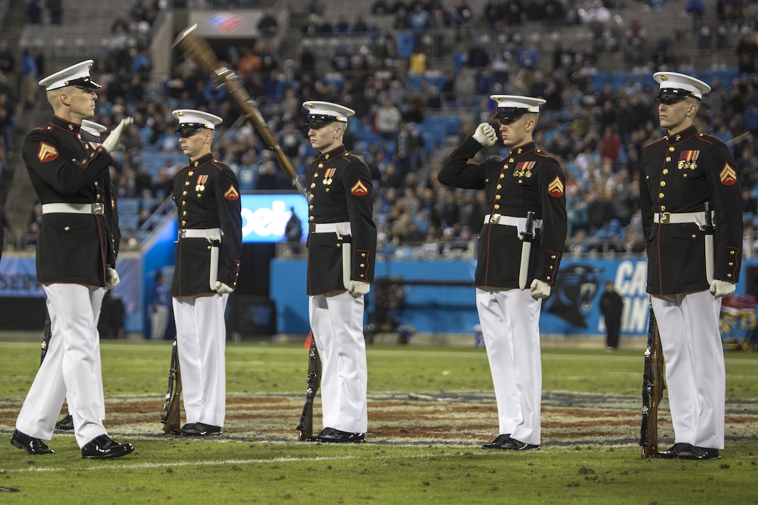 Cpl. Jarris J. Wade, rifle inspector, U.S. Marine Corps Silent Drill Platoon, catches a rifle during a Salute to Service halftime show at a Carolina Panthers vs. Miami Dolphins game at the Bank of America Stadium, Charlotte, N.C., Nov. 13, 2017. Throughout the year, SDP performs at numerous large-scale events across the country and abroad. (Official Marine Corps photo by Cpl. Damon Mclean/Released)