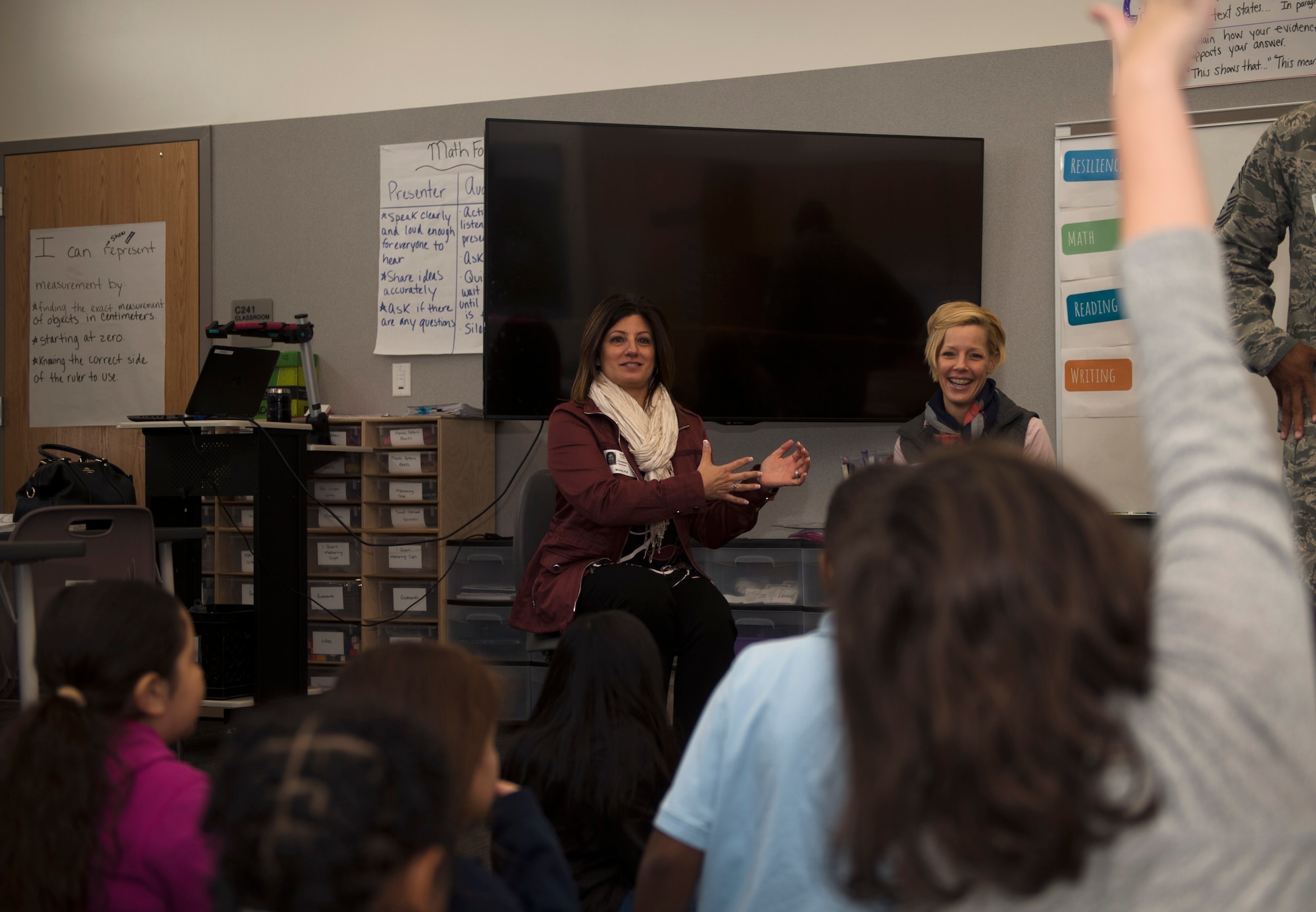 Christine Criswell, wife of Chief Master Sgt. Brendan I. Criswell, Command Chief Master Sergeant, Air Force Space Command, and Stacy Lindsey, wife of Chief Master Sgt. Rod Lindsey, 460th Space Wing command chief, speak to students at Edna and John W. Mosley P-8 School Nov. 9, 2017, in Aurora, Colo.
