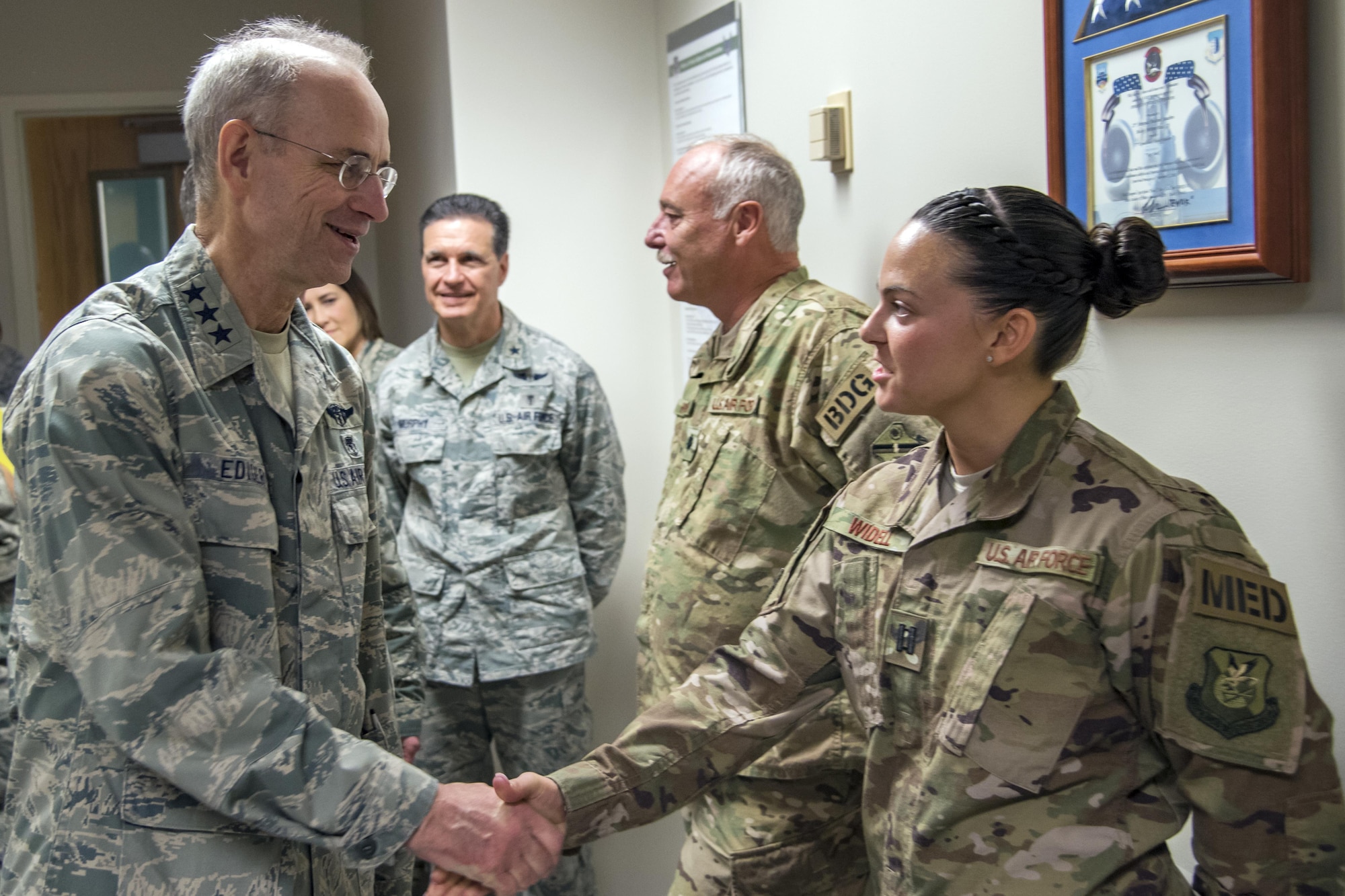 Lt. Gen. Mark Ediger, Surgeon General of the Air Force (AF/SG) shakes hands with Capt. Heather Widdell, 823d Base Defense Squadron medical assistant, Nov.15, 2017, at Moody Air Force Base, Ga. The AF/SG visited Moody to get a better understanding of the 23d Medical Group’s mission. (U.S. Air Force photo by Airman Eugene Oliver)