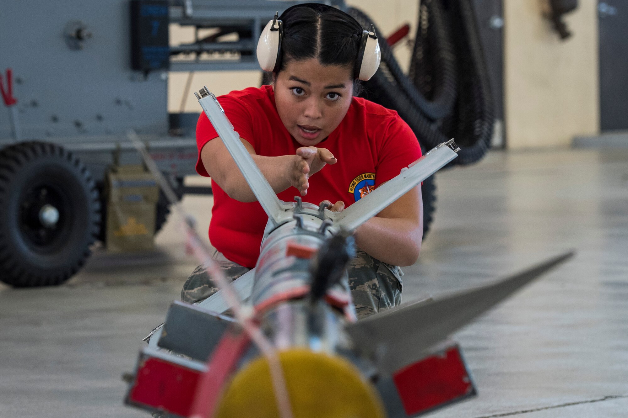 Airman Jasmin Martinez, 75th Aircraft Maintenance Unit (AMU) weapons load crew chief, inspects an inert AIM-9 air-to-air missile during a weapons load competition, Nov. 16, 2017, at Moody Air Force Base, Ga. Every quarter, load crews from the 74th and 75th AMUs compete and are judged based on dress and appearance, a knowledge exam and loading various munitions to determine the quickest and most efficient load crew. (U.S. Air Force photo by Senior Airman Janiqua P. Robinson)
