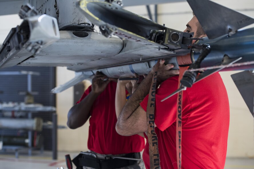 The 75th Aircraft Maintenance Unit (AMU) load crew installs an inert AIM-9 air-to-air missile during a weapons load competition, Nov. 16, 2017, at Moody Air Force Base, Ga. Every quarter, load crews from the 74th and 75th AMUs compete and are judged based on dress and appearance, a knowledge exam and loading various munitions to determine the quickest and most efficient load crew. (U.S. Air Force photo by Senior Airman Janiqua P. Robinson)