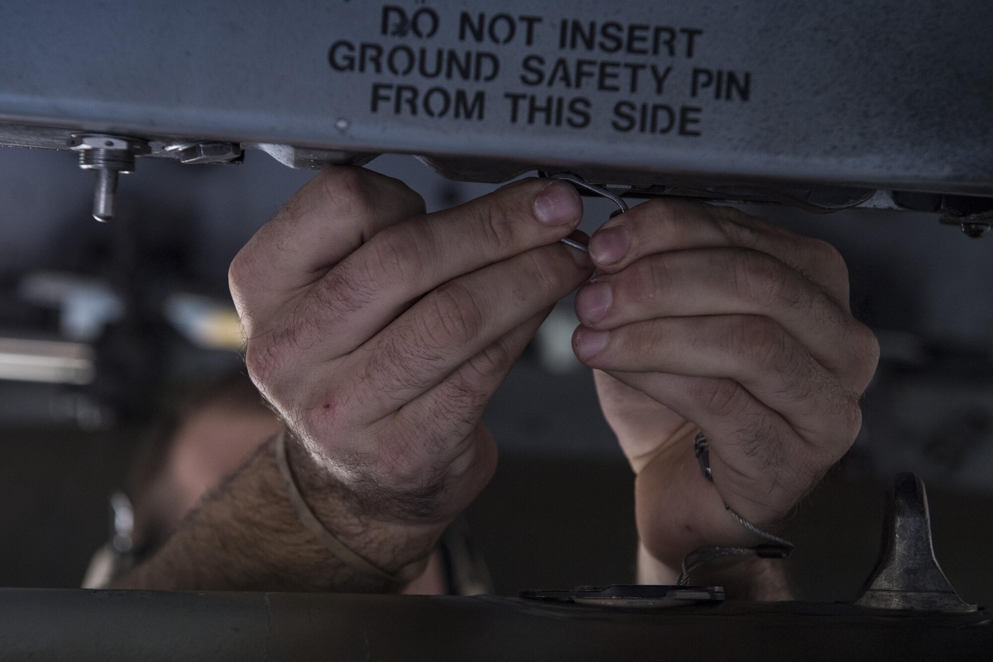 Staff Sgt. Kyle Davey, 75th AMU weapons load crew chief (AMU), installs a MK-84 general purpose bomb during a weapons load competition, Nov. 16, 2017, at Moody Air Force Base, Ga. The 74th AMU won the competition this quarter, defeating the 75th AMU. Teams are chosen based on weapons loading and maintenance performance during the previous quarter. (U.S. Air Force photo by Senior Airman Janiqua P. Robinson)