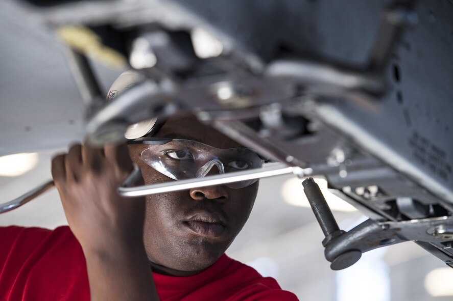 Airman 1st Class Devonta’ Edmonds, 75th Aircraft Maintenance Unit (AMU) weapons load crew chief, prepares an A-10C Thunderbolt II to house a munition during a weapons load competition, Nov. 16, 2017, at Moody Air Force Base, Ga. Every quarter, load crews from the 74th and 75th AMUs compete and are judged based on dress and appearance, a knowledge exam and loading various munitions to determine the quickest and most efficient load crew. (U.S. Air Force photo by Senior Airman Janiqua P. Robinson)