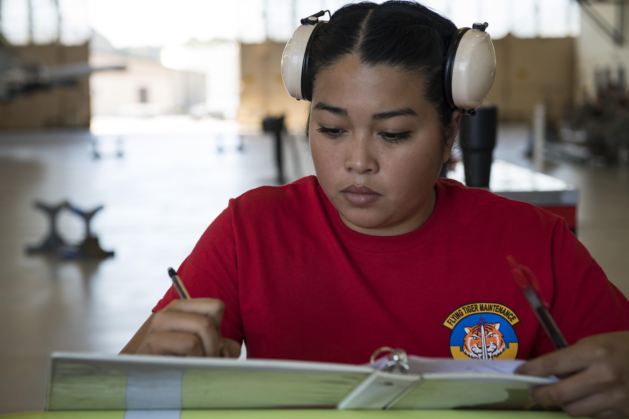 Airman Jasmin Martinez, 75th Aircraft Maintenance Unit (AMU) weapons load crew chief, fills out paperwork during a weapons load competition, Nov. 16, 2017, at Moody Air Force Base, Ga.  The 74th AMU won the competition this quarter, defeating the 75th AMU. Teams are chosen based on weapons loading and maintenance performance during the previous quarter. (U.S. Air Force photo by Senior Airman Janiqua P. Robinson)