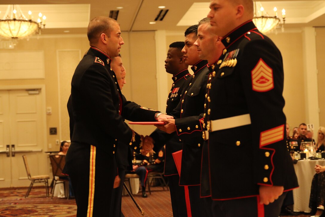 Sgt. Domingo Hernandez receives the award for Recruiter of the Year for Recruiting Station Oklahoma City before the beginning of the Marine Corps Ball.   Hernandez has been moved from being a recruiter on production to being a Staff NCOIC for Recruiting Substation Midwest City.